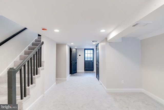 hall featuring light colored carpet