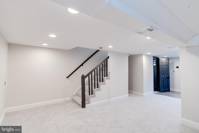 basement featuring light carpet