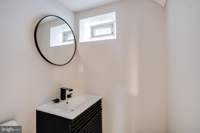 bathroom featuring toilet and vanity