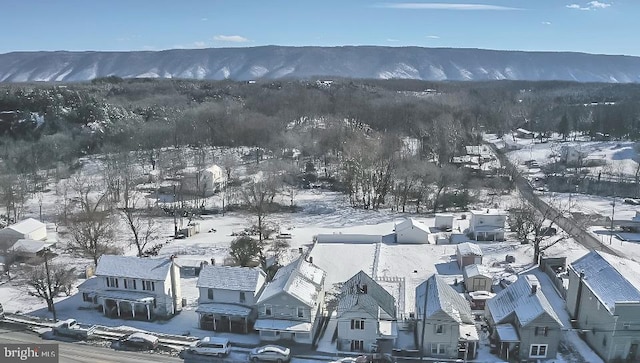 snowy aerial view featuring a mountain view