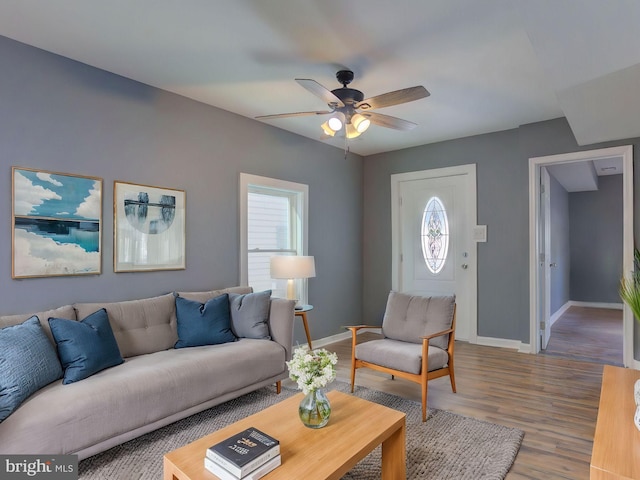 living room with ceiling fan and wood-type flooring