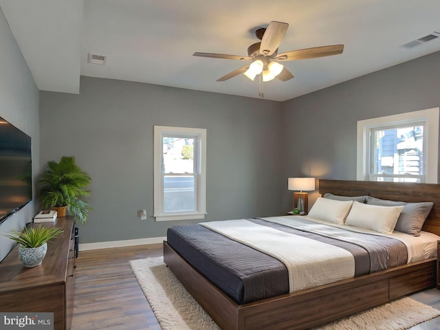 bedroom with ceiling fan and hardwood / wood-style floors