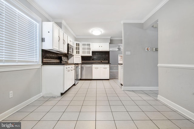 kitchen with white cabinetry, backsplash, crown molding, and stainless steel appliances