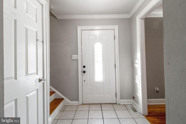 tiled entrance foyer with ornamental molding