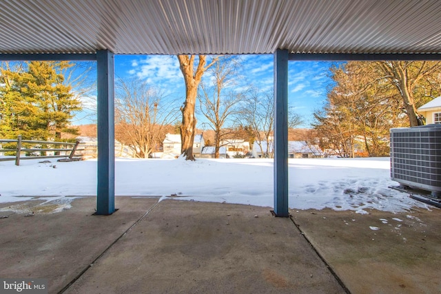 yard layered in snow with central air condition unit