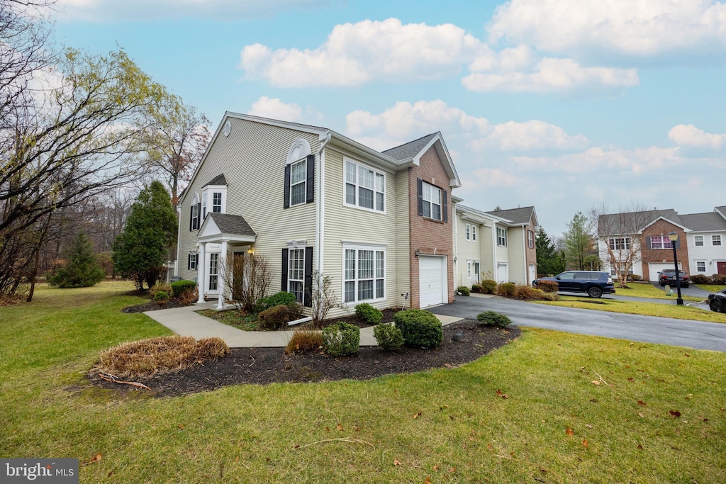 view of front of property featuring a garage and a front yard