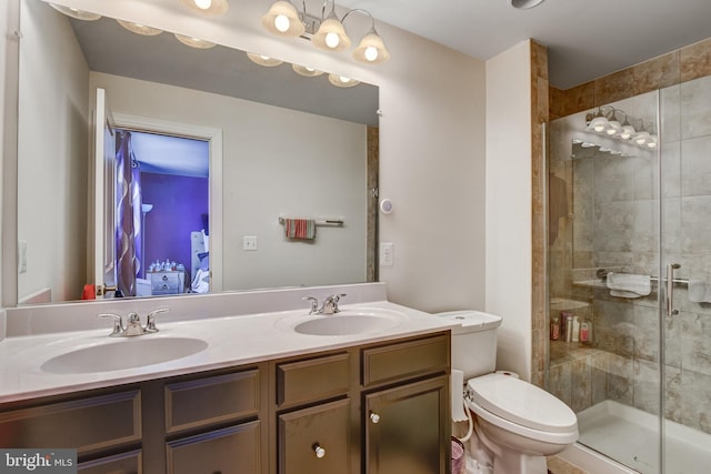 bathroom with vanity, toilet, and a shower with shower door