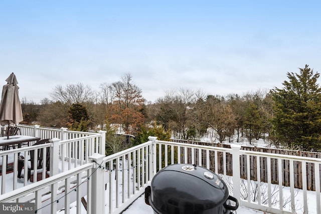 snow covered deck featuring grilling area