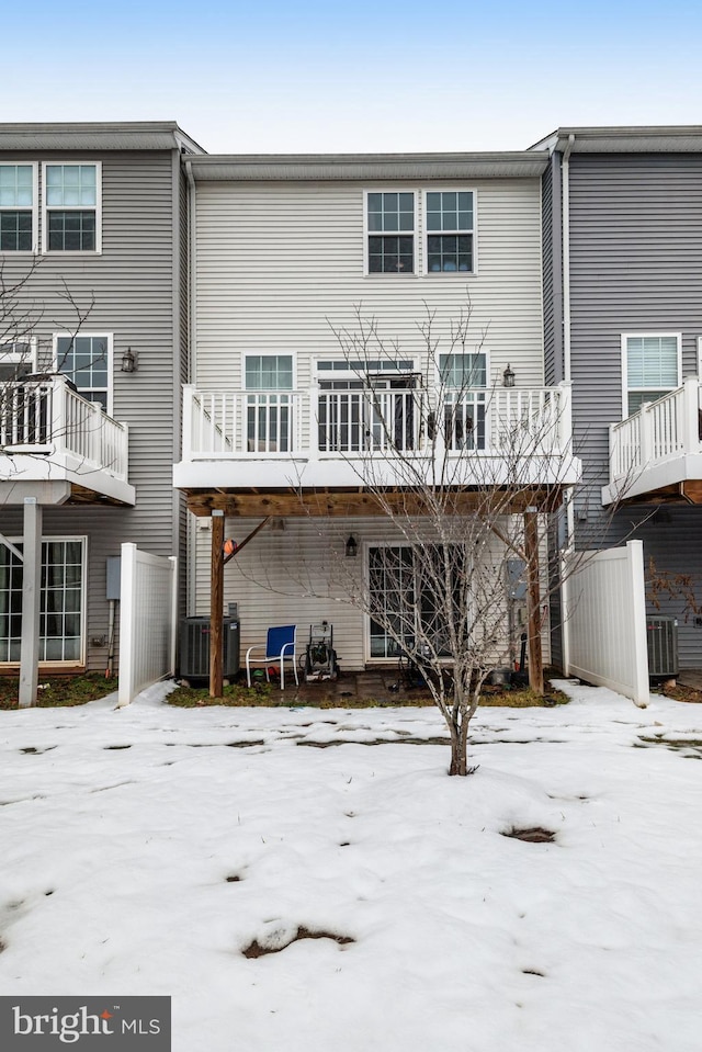 view of snow covered back of property