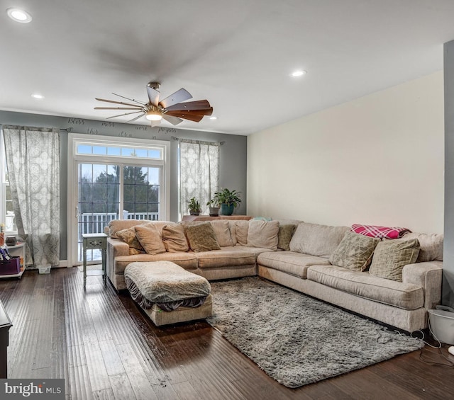 living room with dark hardwood / wood-style floors and ceiling fan