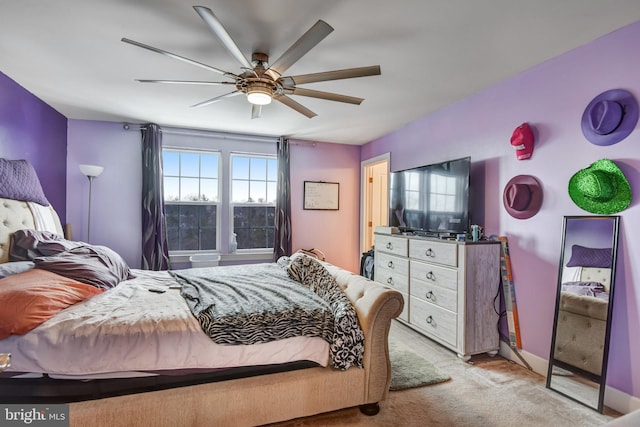 bedroom with multiple windows, light colored carpet, and ceiling fan