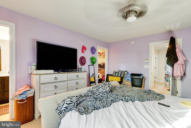 bedroom featuring ensuite bathroom, a spacious closet, and a closet