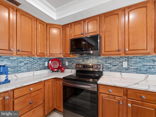 kitchen featuring ornamental molding, light stone counters, decorative backsplash, and appliances with stainless steel finishes