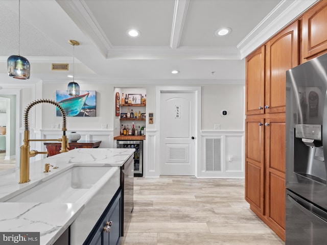 kitchen with light stone countertops, pendant lighting, wine cooler, sink, and stainless steel fridge with ice dispenser