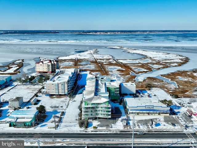 snowy aerial view with a water view