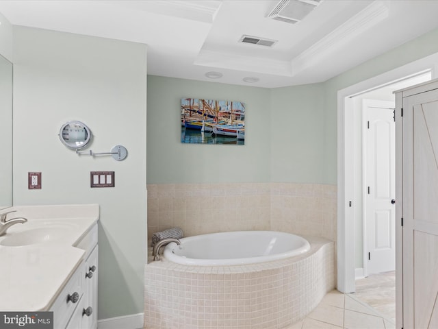 bathroom with crown molding, tiled tub, a raised ceiling, tile patterned floors, and vanity