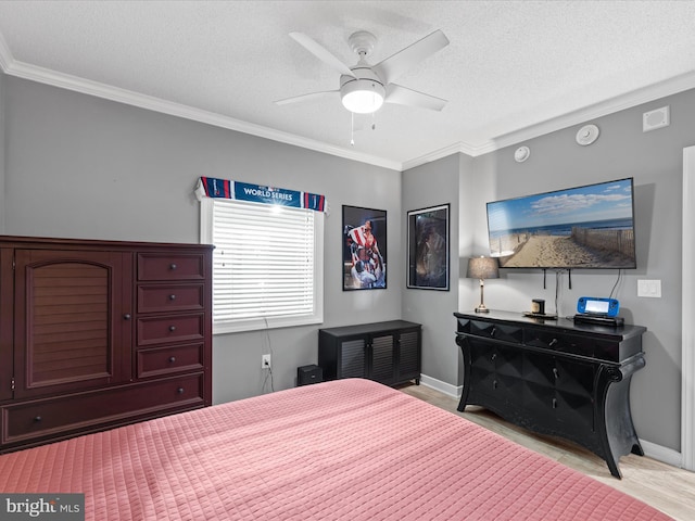 bedroom featuring a textured ceiling, ceiling fan, and ornamental molding