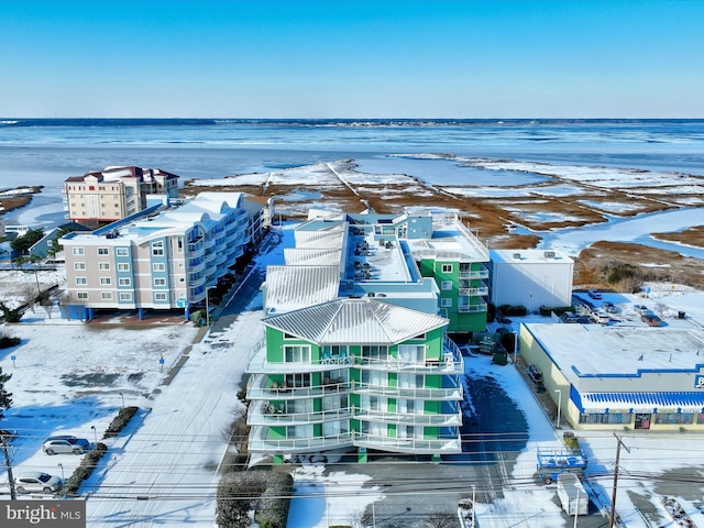 snowy aerial view with a water view