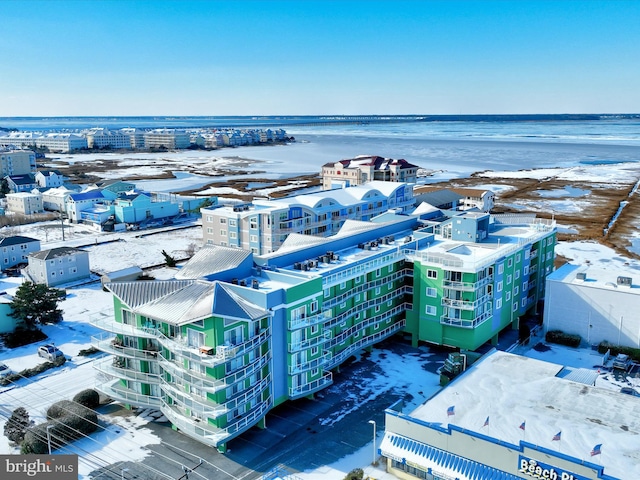 snowy aerial view with a water view