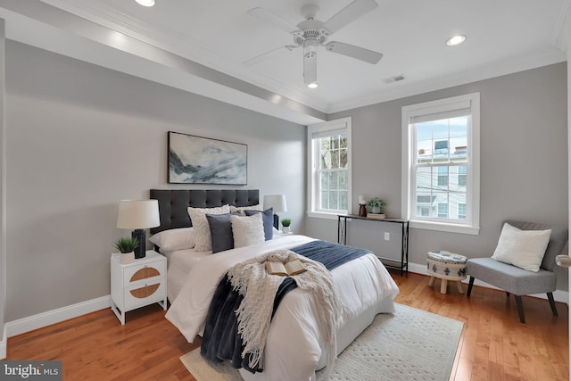 bedroom featuring ornamental molding, ceiling fan, and light wood-type flooring