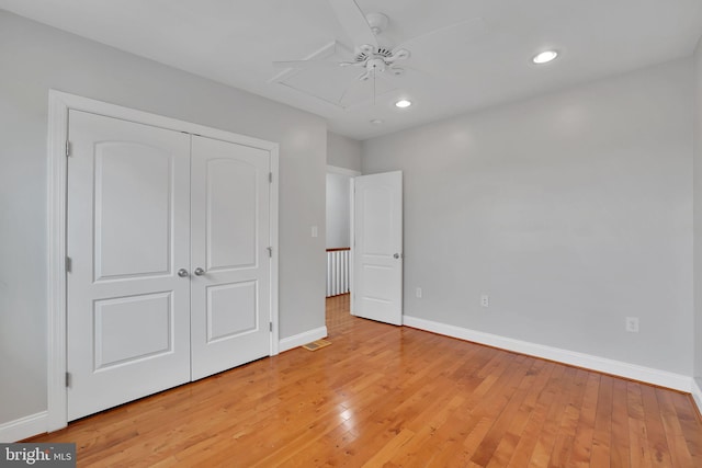 unfurnished bedroom featuring a closet, ceiling fan, and light hardwood / wood-style flooring