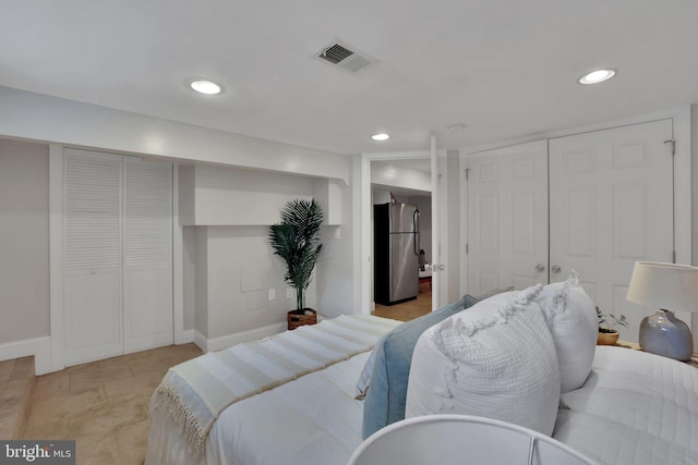 bedroom featuring stainless steel refrigerator