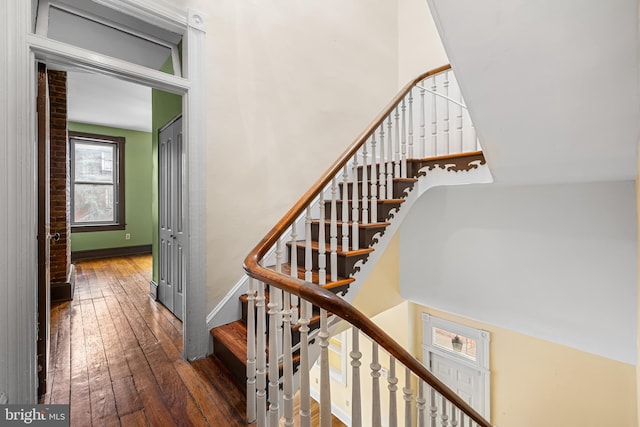 staircase with baseboards and hardwood / wood-style floors