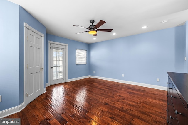 interior space with a ceiling fan, recessed lighting, hardwood / wood-style flooring, and baseboards