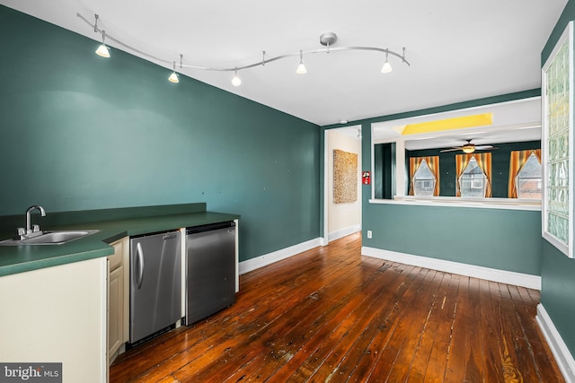 kitchen with stainless steel fridge, baseboards, dark wood-style floors, fridge, and a sink