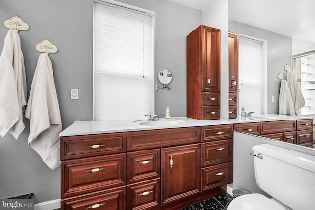 bathroom featuring an enclosed shower, vanity, and toilet