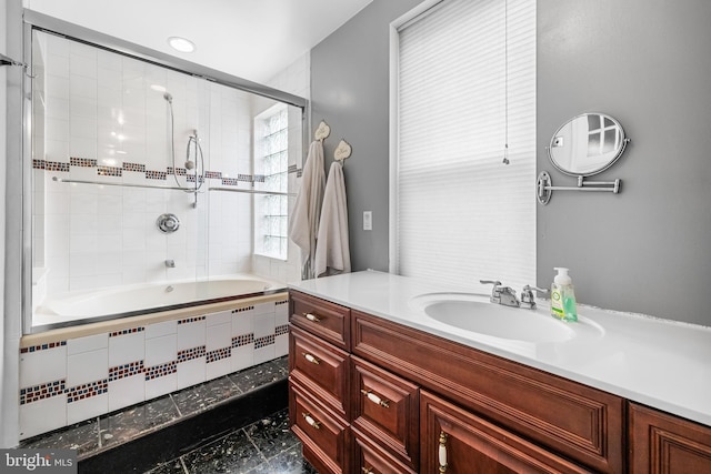 full bathroom featuring tiled shower / bath combo and vanity