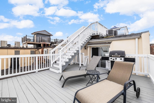 wooden terrace featuring stairs and area for grilling