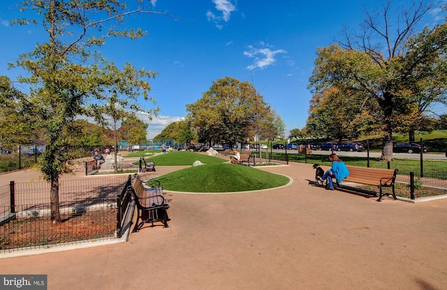 surrounding community featuring fence and a yard