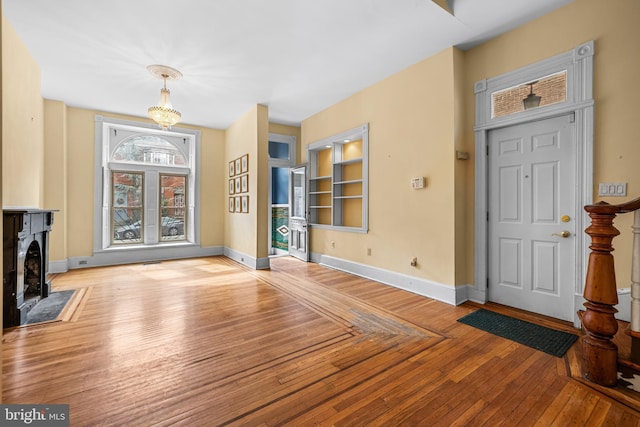 interior space featuring hardwood / wood-style floors, built in features, and baseboards