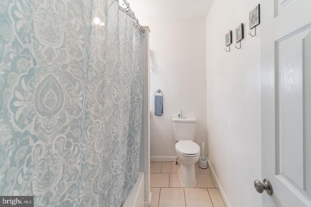 bathroom featuring toilet and tile patterned flooring