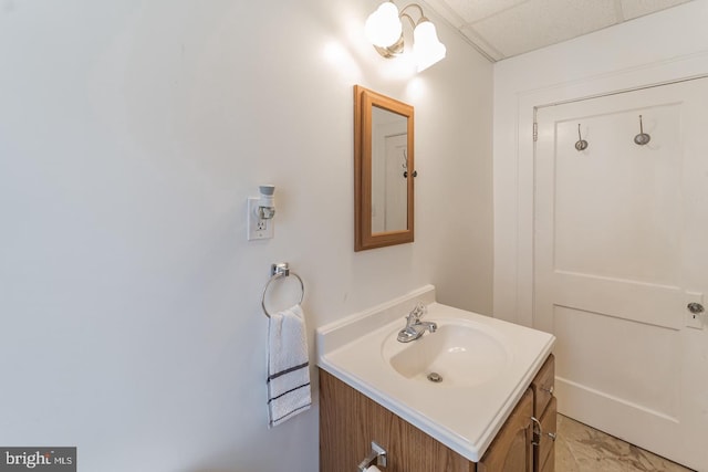 bathroom featuring a drop ceiling and vanity