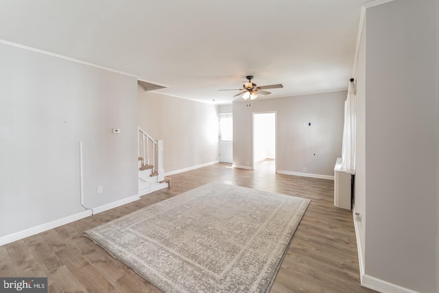 empty room with hardwood / wood-style flooring, ceiling fan, and ornamental molding