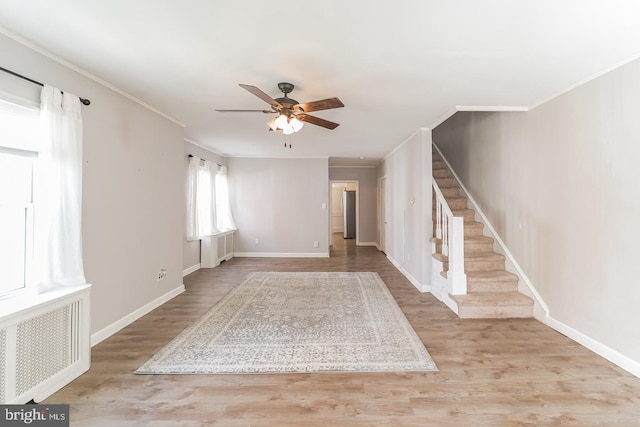 interior space with crown molding, light hardwood / wood-style flooring, and ceiling fan