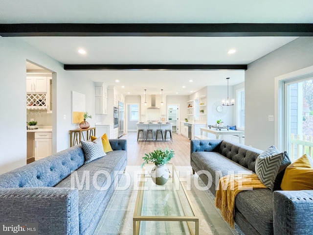 living room featuring a chandelier and light hardwood / wood-style floors