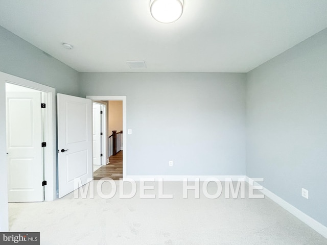 unfurnished bedroom with light colored carpet