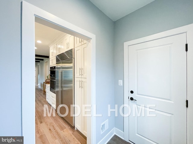 hallway with light hardwood / wood-style flooring