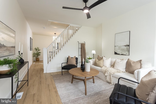 living room featuring ceiling fan and light wood-type flooring