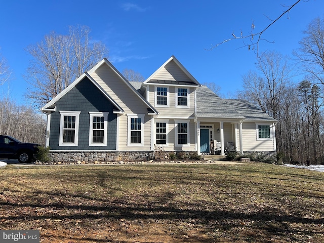 view of front property featuring covered porch and a front yard