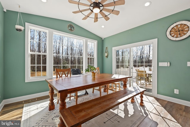 dining room with lofted ceiling, hardwood / wood-style floors, a healthy amount of sunlight, and ceiling fan