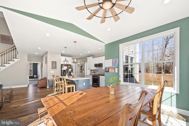 dining area with lofted ceiling, dark wood-type flooring, and ceiling fan