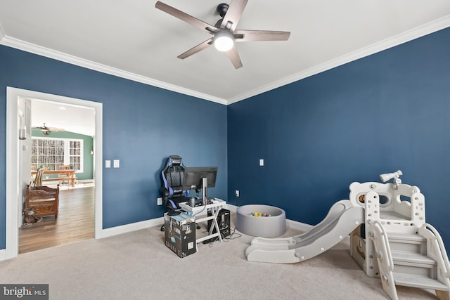 interior space featuring crown molding, carpet floors, and ceiling fan