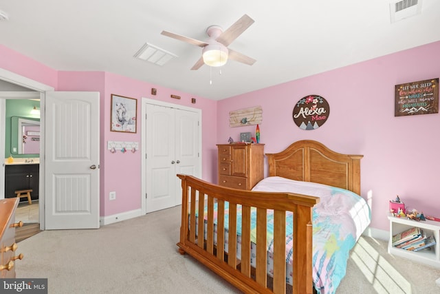 carpeted bedroom with ceiling fan and a closet