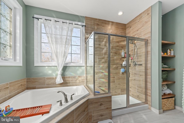 bathroom featuring separate shower and tub