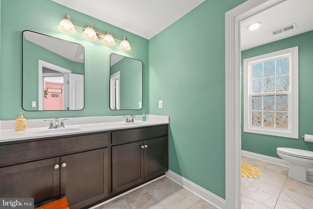 bathroom featuring tile patterned flooring, vanity, and toilet