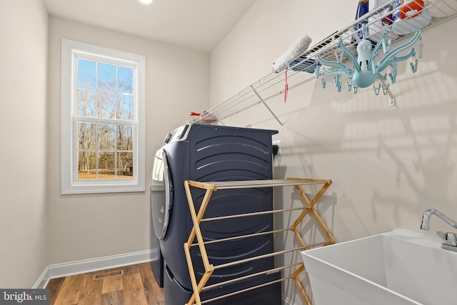 interior space featuring wood-type flooring, sink, and washer and dryer